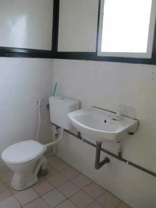Bathroom sink and toilet inside an Aguna Resort chalet