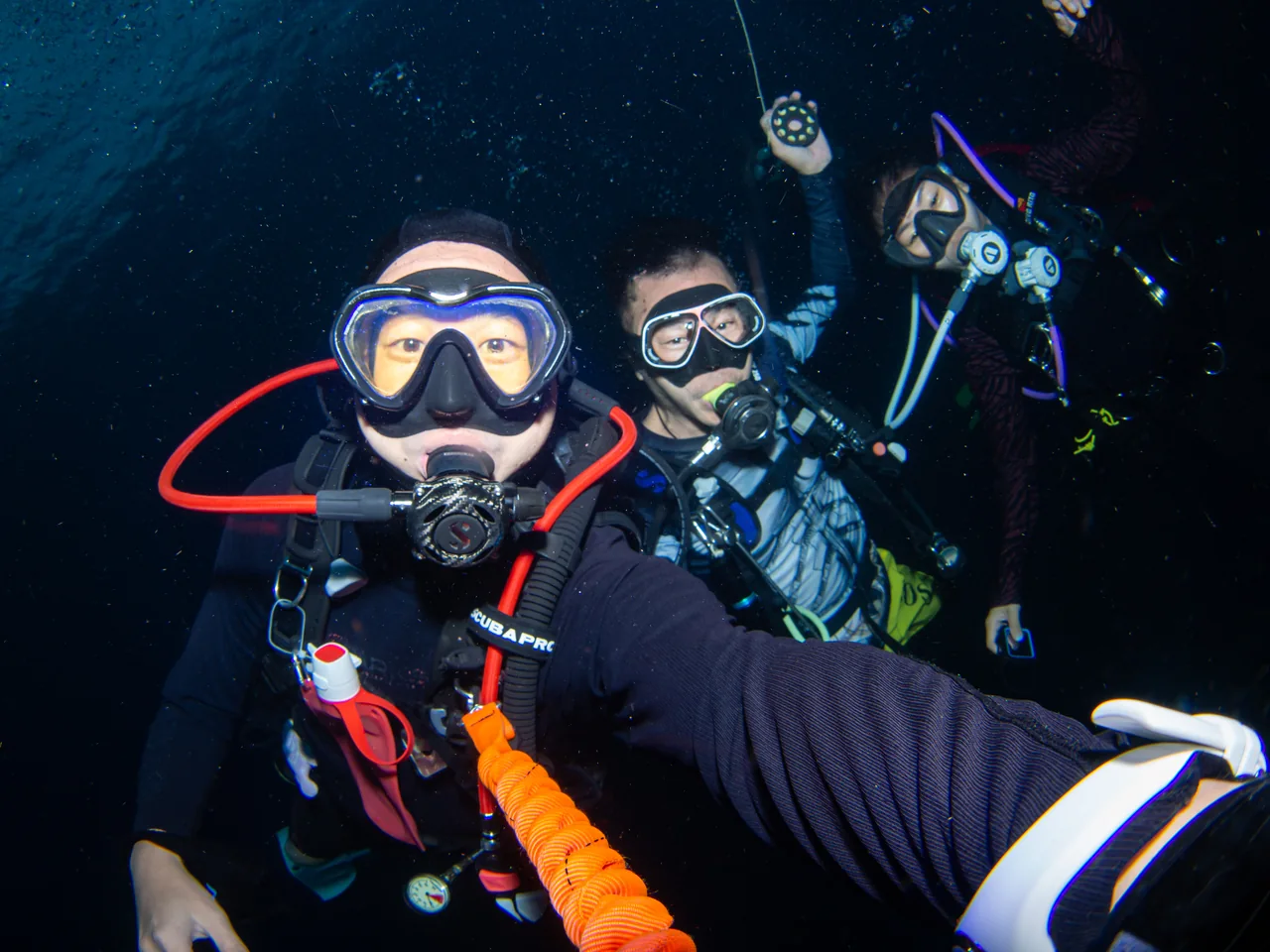 Dive buddies taking an underwater group photograph