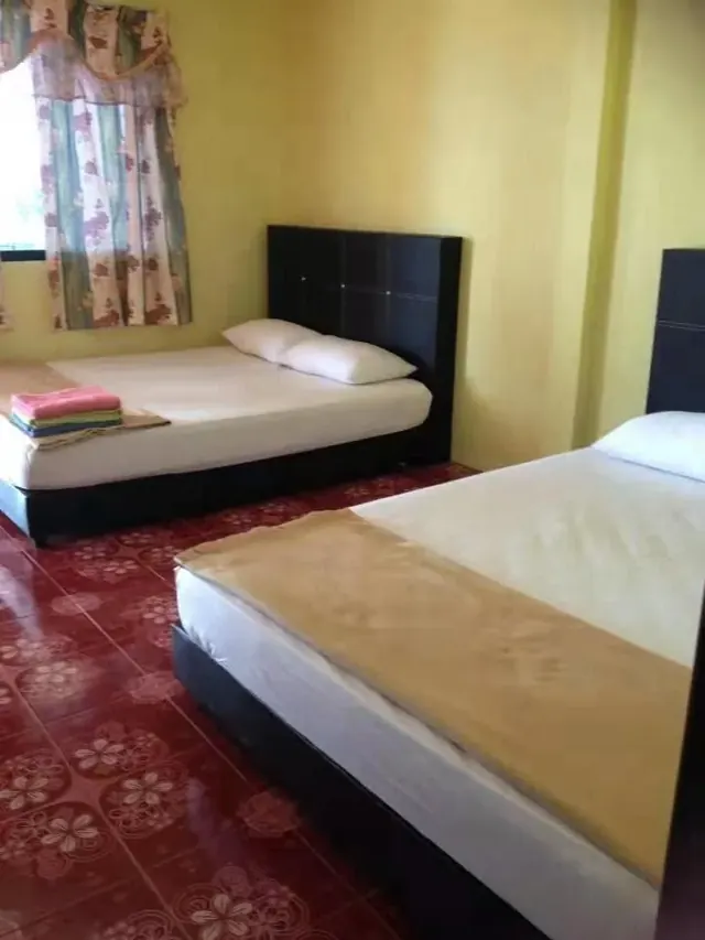 Two beds beside the window in an Idaman quad room