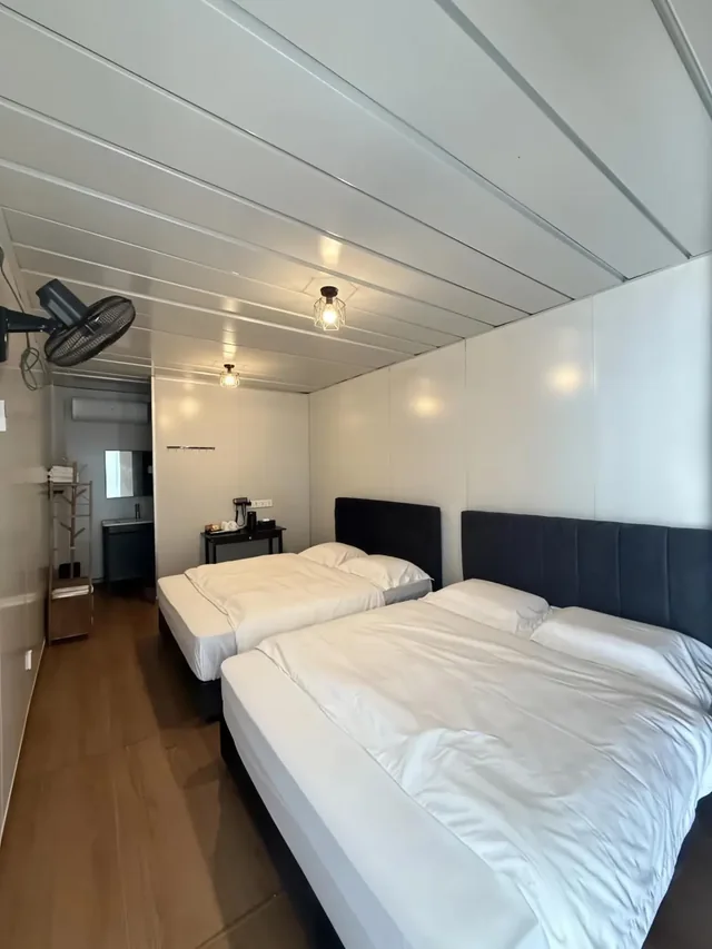 Two queen beds in a TDB Tioman Resort deluxe room